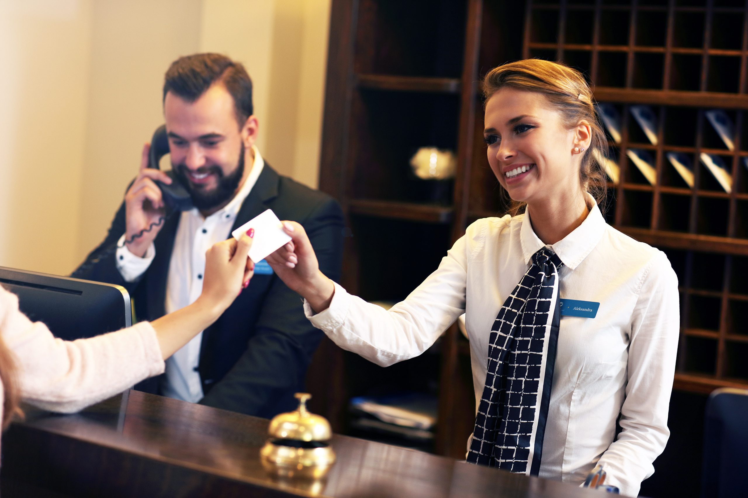 Guests-getting-key-card-in-hotel-640147624_2738x1825